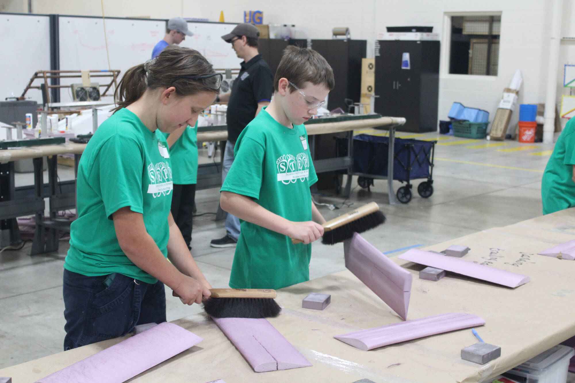 STEPS students build their planes inside the Innovation Design Center